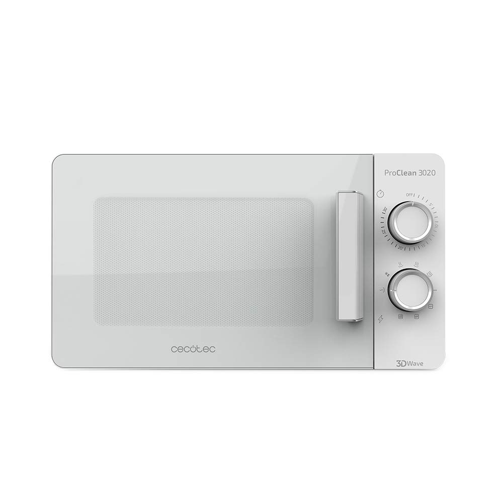 Micro-ondes blanc à porte claire et commandes rotatives, posé sur un plan de travail en bois clair.
