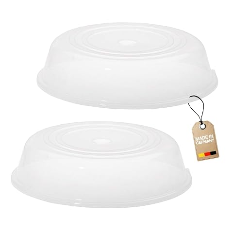 Deux cloches transparentes Westmark pour assiettes, dont une posée sur un plat à réchauffer au micro-ondes