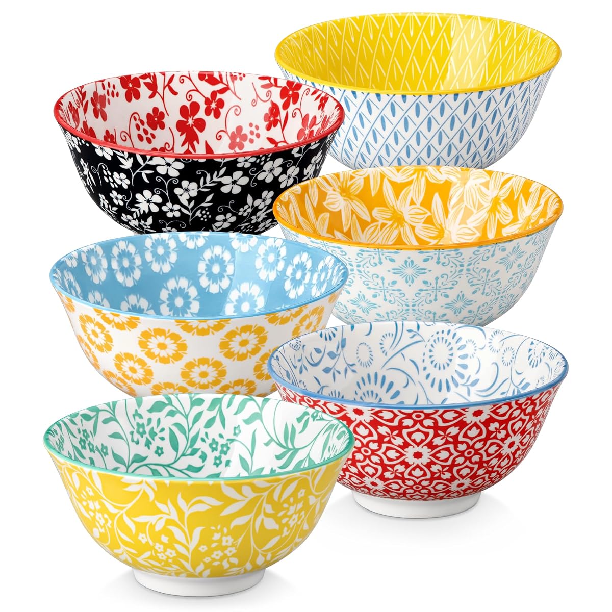 Six bols en porcelaine aux motifs floraux pastel, un devant et cinq empilés sur un plan de travail.